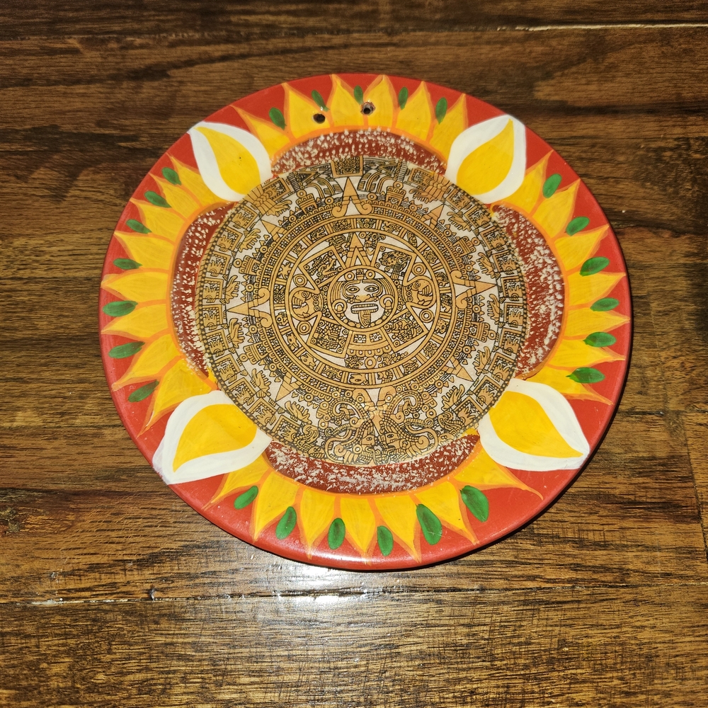 hand-painted Mexican clay plate featuring a vibrant sunflower border and a depic
